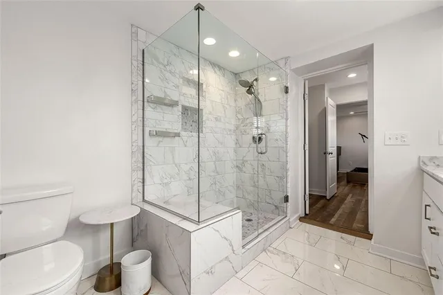 a bathroom with a toilet and a shower