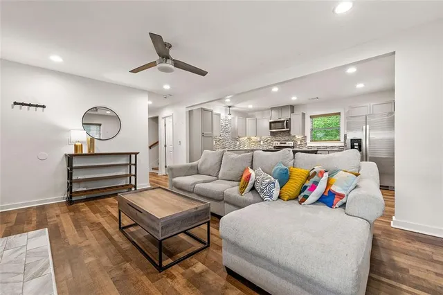 a living room with furniture and kitchen view