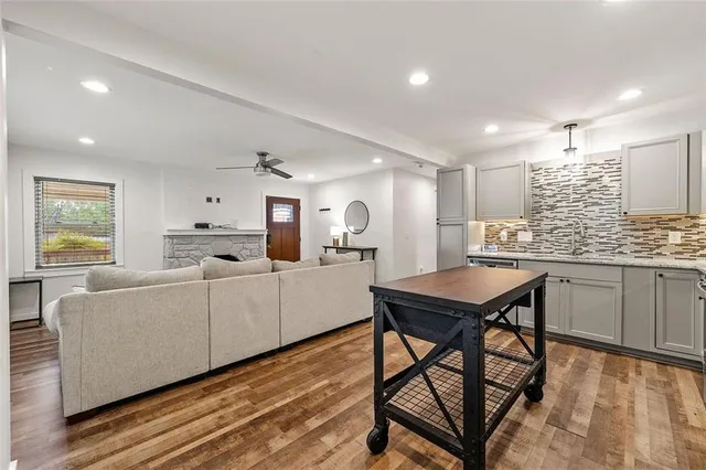 a kitchen with a table chairs a sink dishwasher window and cabinets
