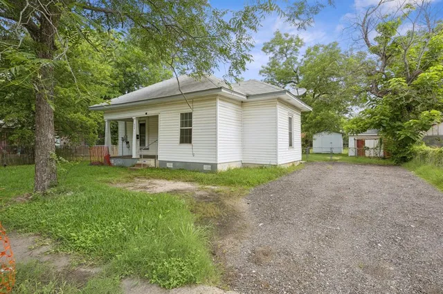 a front view of house with yard and trees