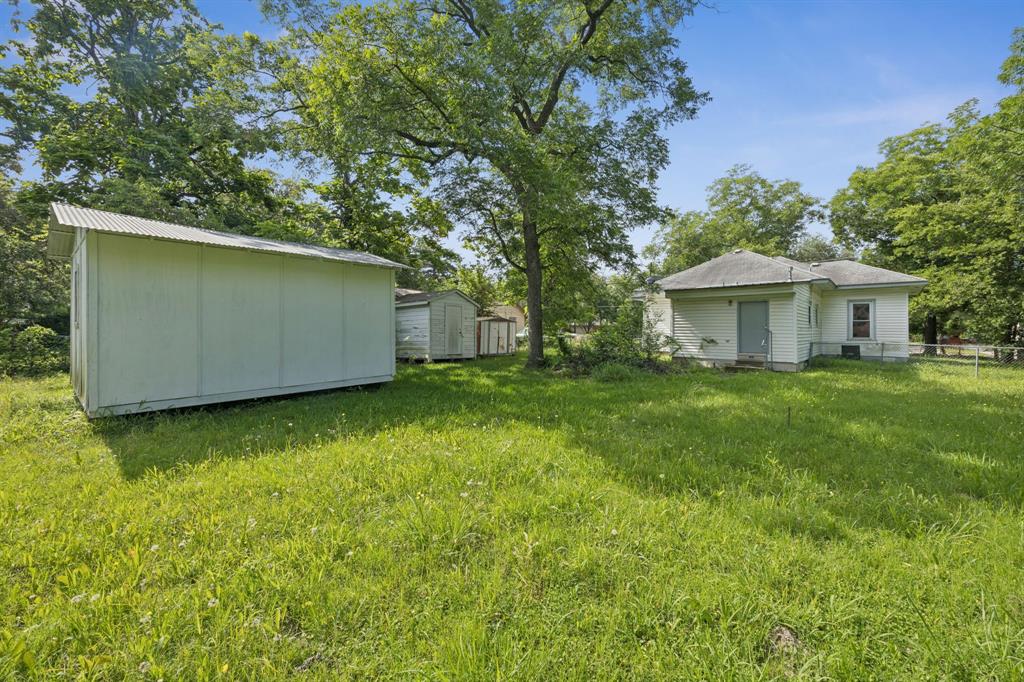 909 East High Street Terrell, TX 75160 - Photo 22 of 24 a view of a house with a backyard