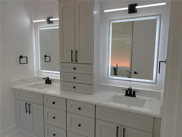 a bathroom with a double vanity sink mirror and double