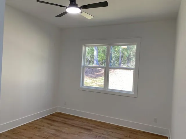 wooden floor in an empty room with a window
