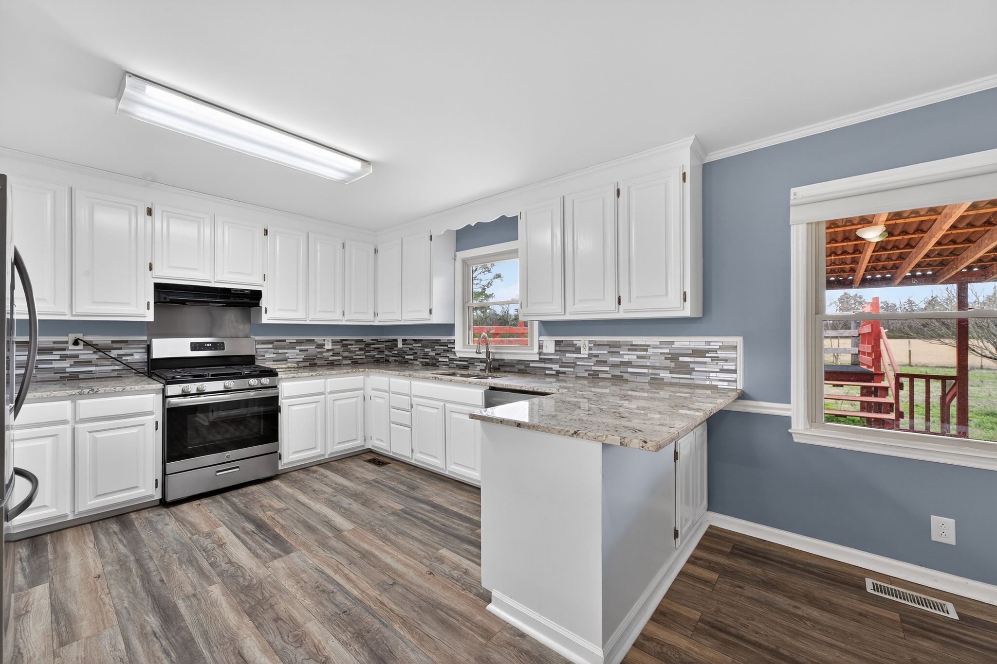 4377 Windrow Road Rockvale, TN 37153 - Photo 5 of 22 a kitchen with granite countertop white cabinets appliances and a window