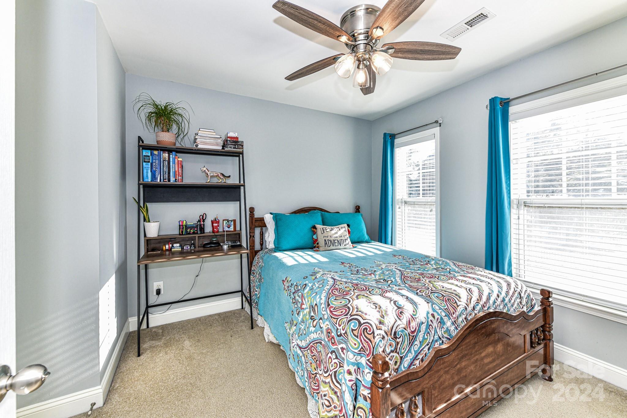 331 Hurston Circle Charlotte, NC 28208 - Photo 16 of 28 a bedroom with a bed and a chandelier