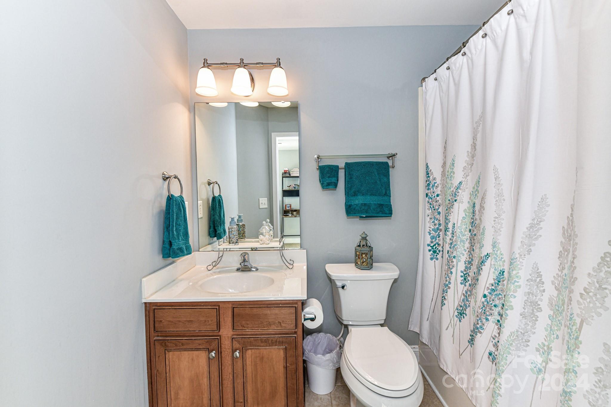 331 Hurston Circle Charlotte, NC 28208 - Photo 17 of 28 a bathroom with a toilet a sink and a mirror