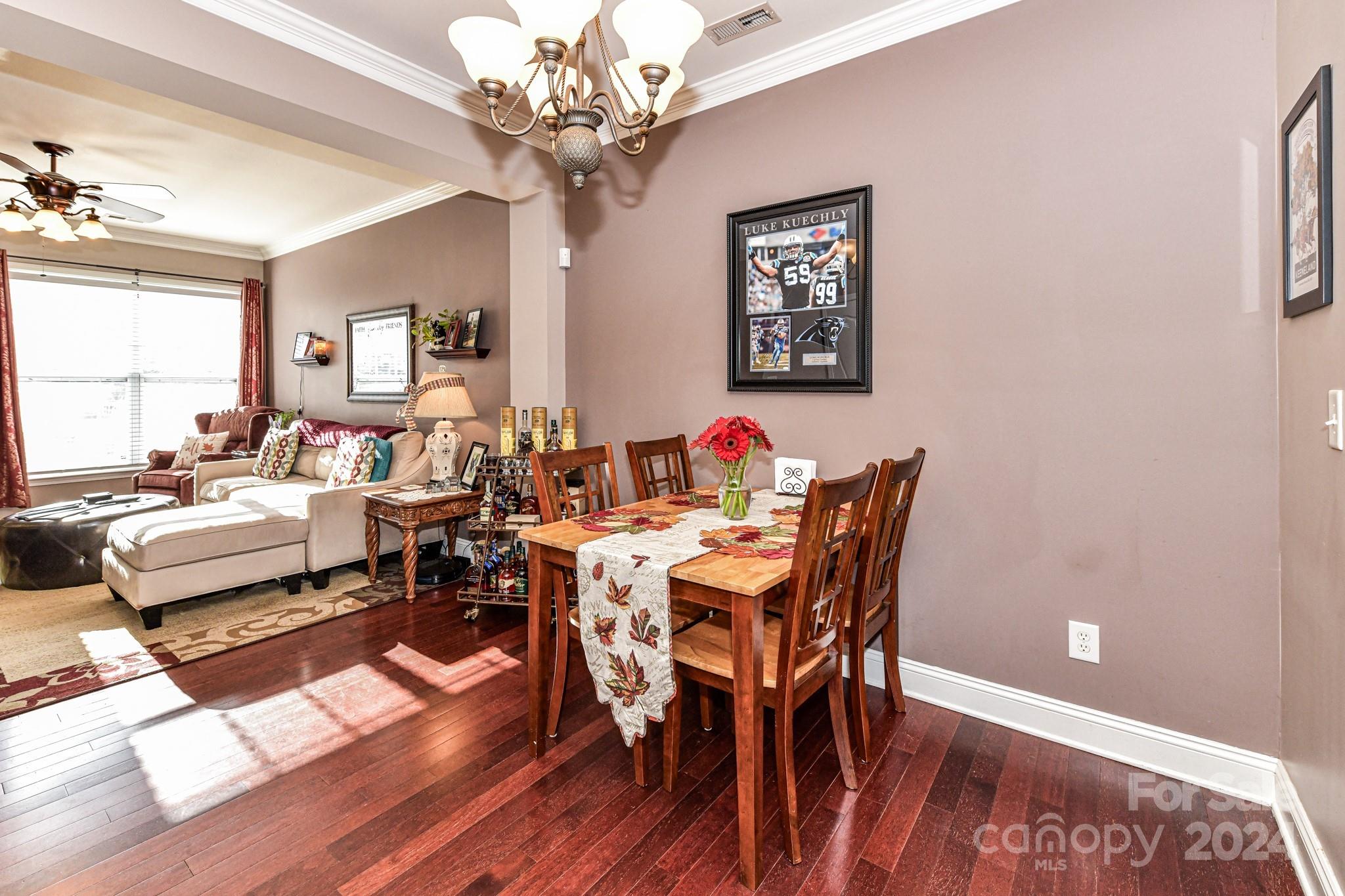 331 Hurston Circle Charlotte, NC 28208 - Photo 5 of 28 a view of a dining room with furniture a chandelier and wooden floor