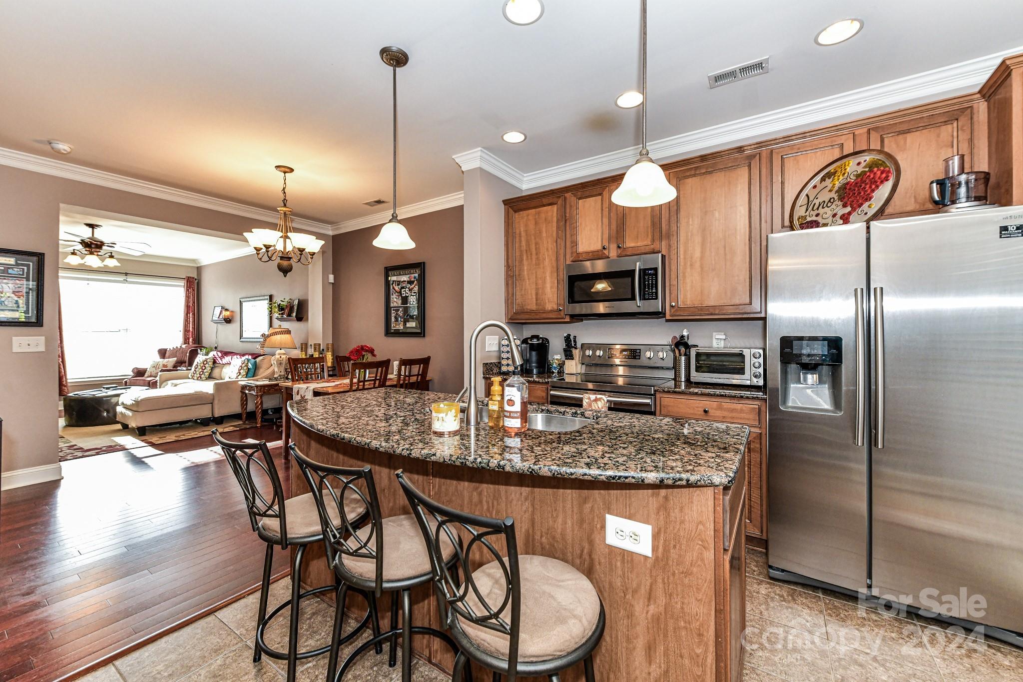 331 Hurston Circle Charlotte, NC 28208 - Photo 6 of 28 a kitchen with stainless steel appliances granite countertop a stove a refrigerator a kitchen island a sink and a refrigerator