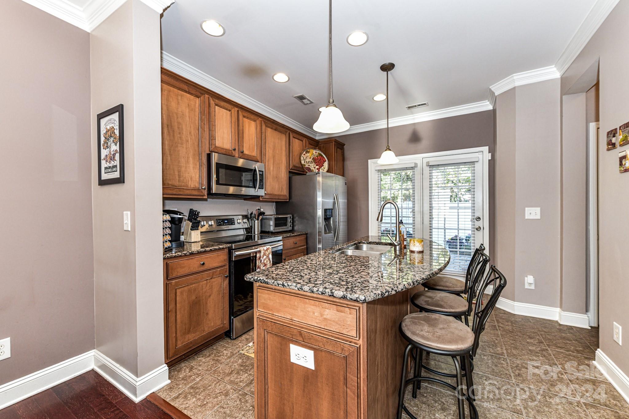 331 Hurston Circle Charlotte, NC 28208 - Photo 7 of 28 a kitchen with stainless steel appliances granite countertop a stove oven and a refrigerator