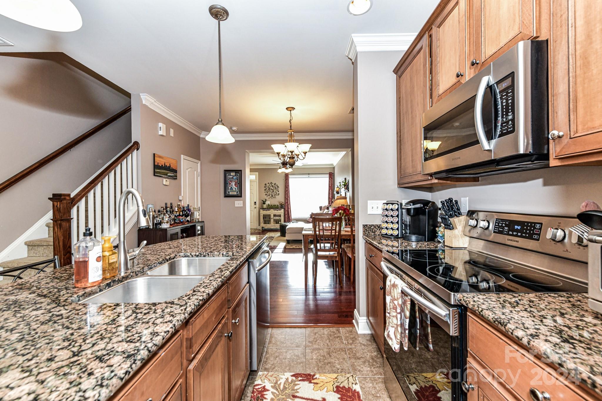 331 Hurston Circle Charlotte, NC 28208 - Photo 8 of 28 a kitchen with stainless steel appliances granite countertop a stove a sink and a microwave