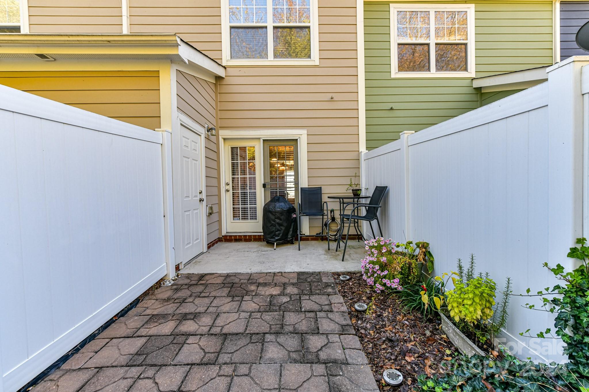 331 Hurston Circle Charlotte, NC 28208 - Photo 10 of 28 a view of a patio with table and chairs and potted plants