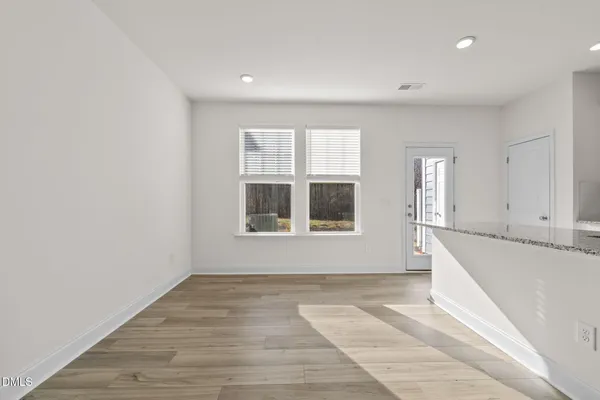 a kitchen with a sink and wooden floor