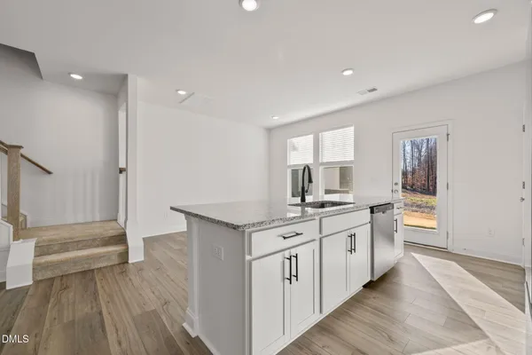 a kitchen with stainless steel appliances a stove a microwave and a refrigerator