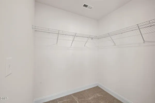 a bathroom with a double vanity sink and mirror with toilet