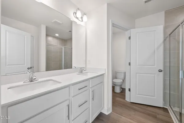 a bathroom with a glass shower door