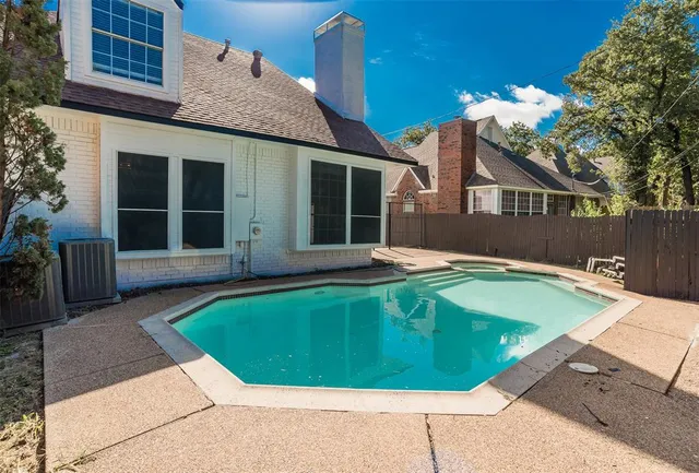 a view of a backyard with swimming pool