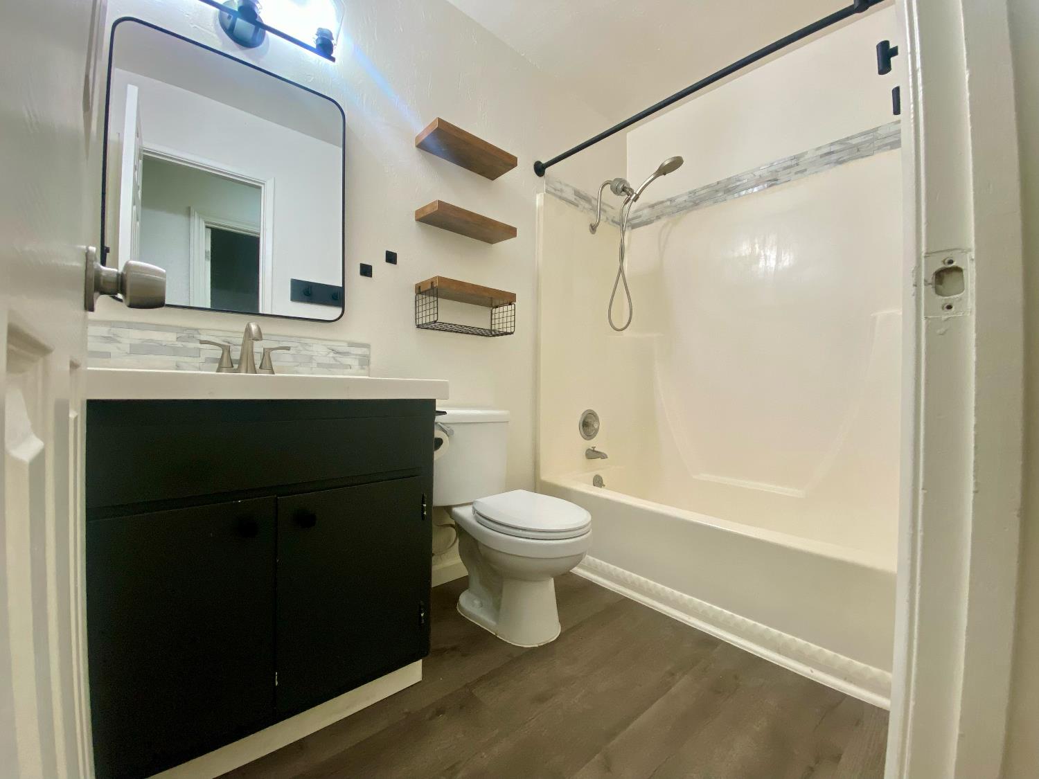 2301 McRitchie Way Modesto, CA 95355 - Photo 12 of 22 a bathroom with a sink a toilet and shower