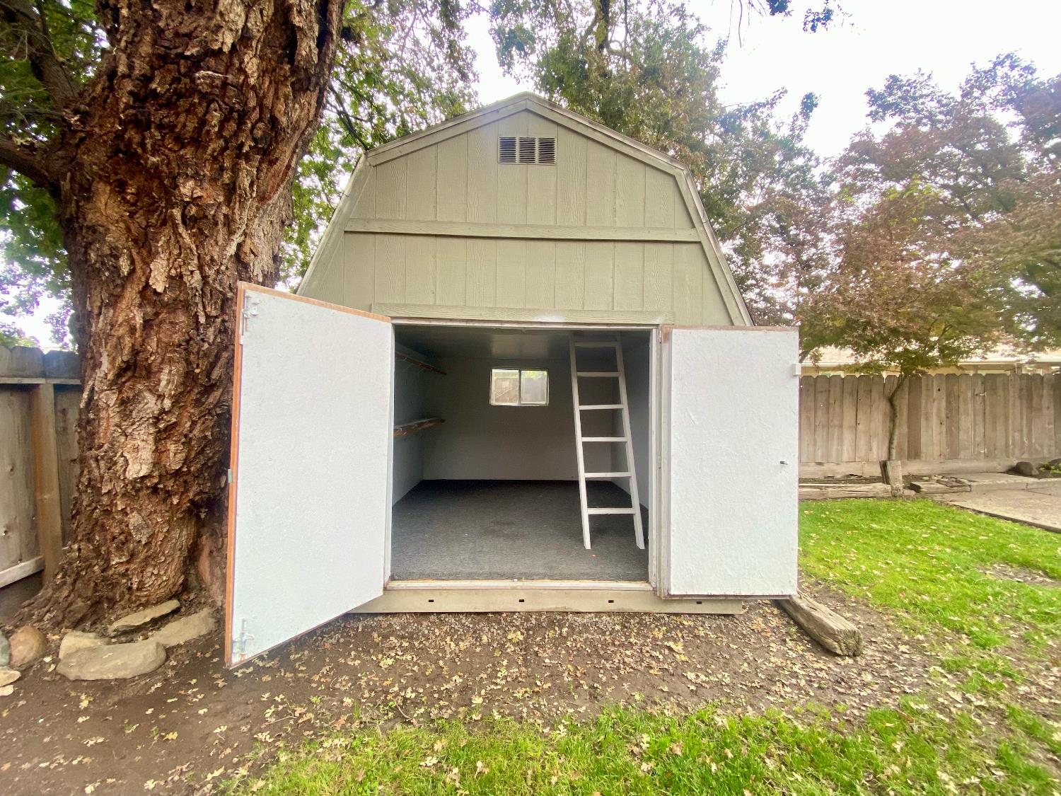 2301 McRitchie Way Modesto, CA 95355 - Photo 19 of 22 a view of a house with a yard and garage