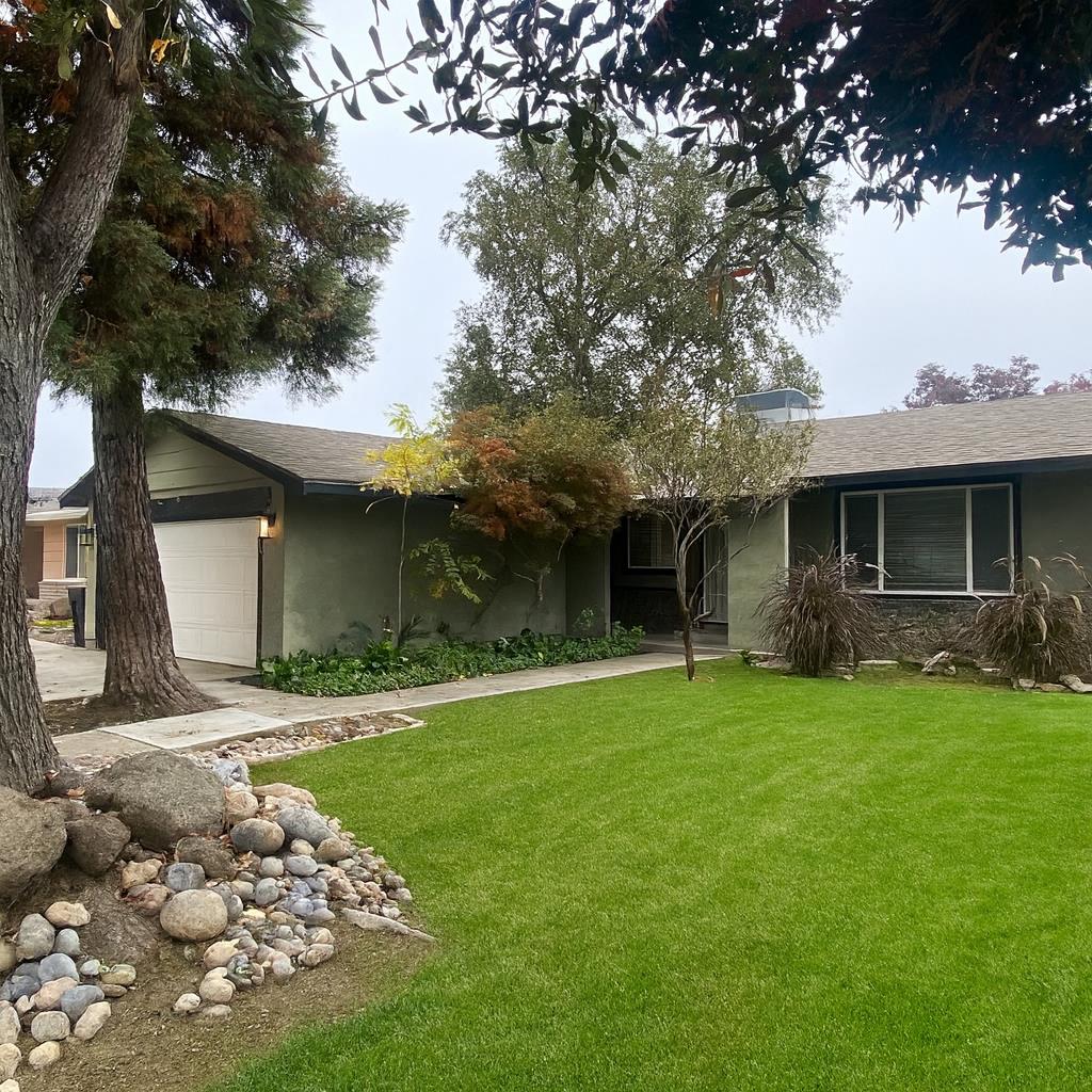 2301 McRitchie Way Modesto, CA 95355 - Photo 3 of 22 a front view of a house with a garden