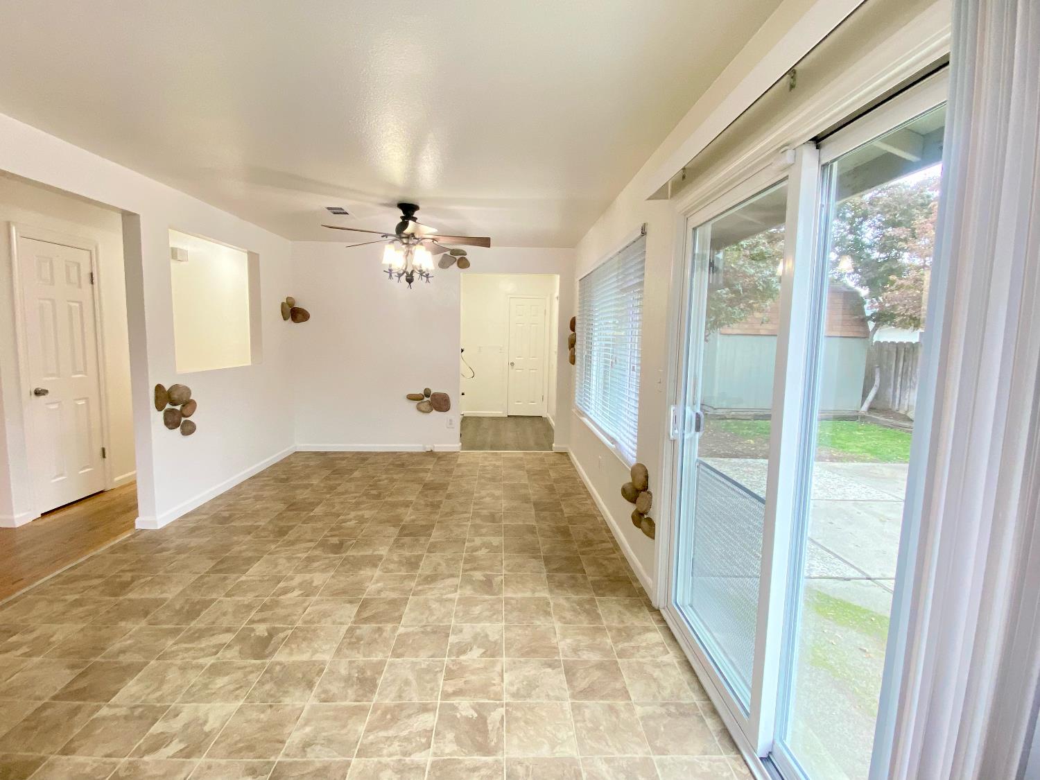 2301 McRitchie Way Modesto, CA 95355 - Photo 7 of 22 a view of a hallway to a livingroom with a furniture