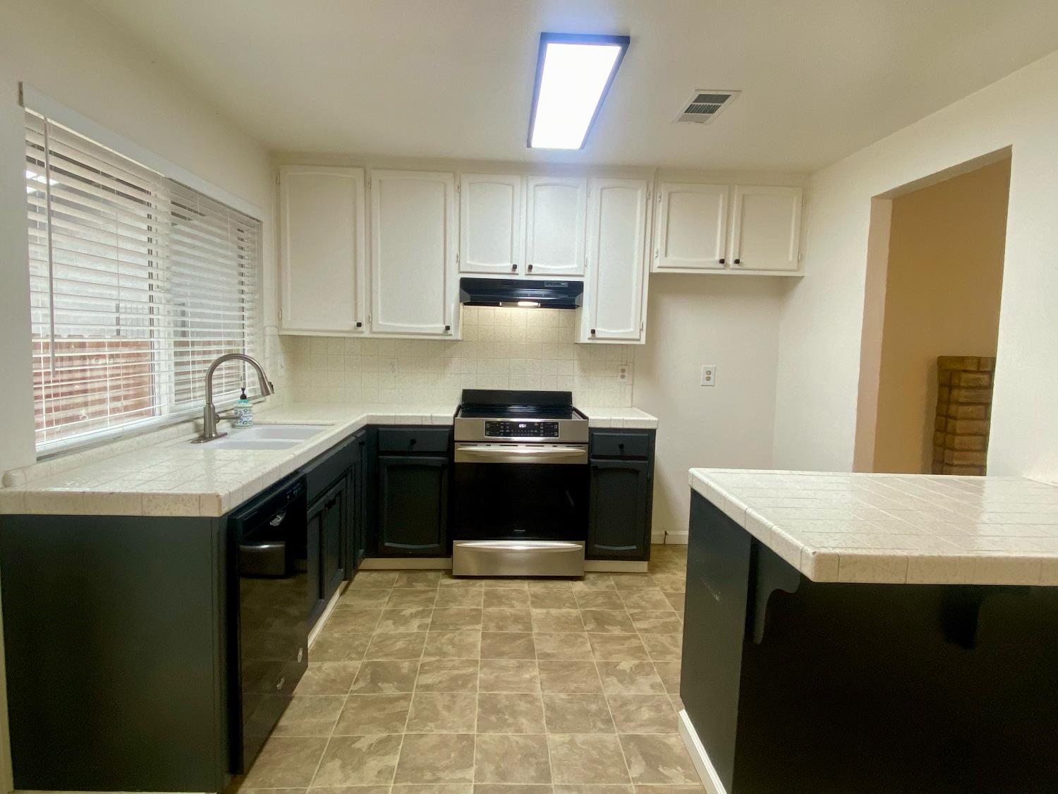 2301 McRitchie Way Modesto, CA 95355 - Photo 10 of 22 a kitchen with a sink and a stove