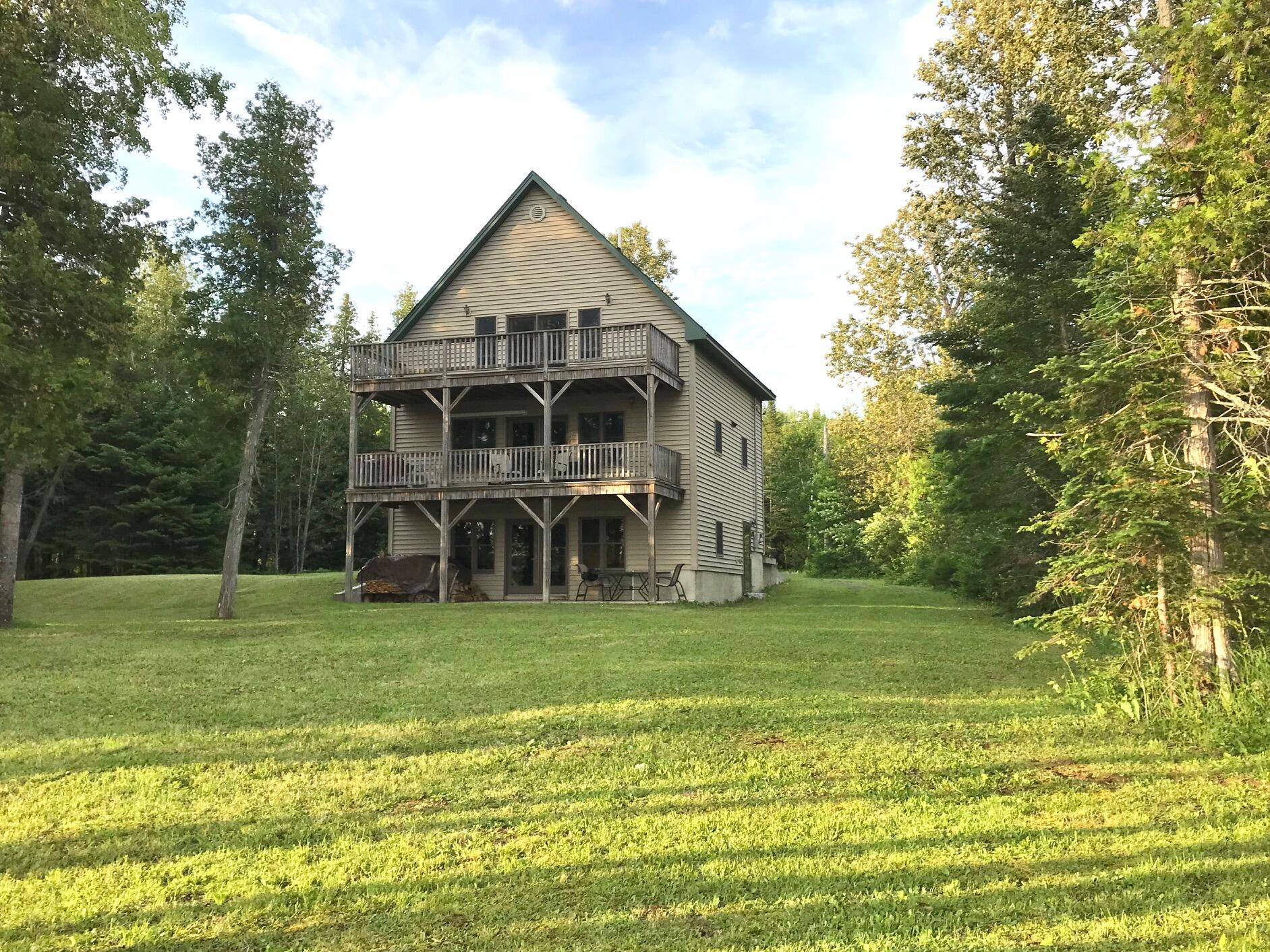 303 East Cottage Road Portage, ME 04768 - Photo 1 of 8 Multi-level waterfront home