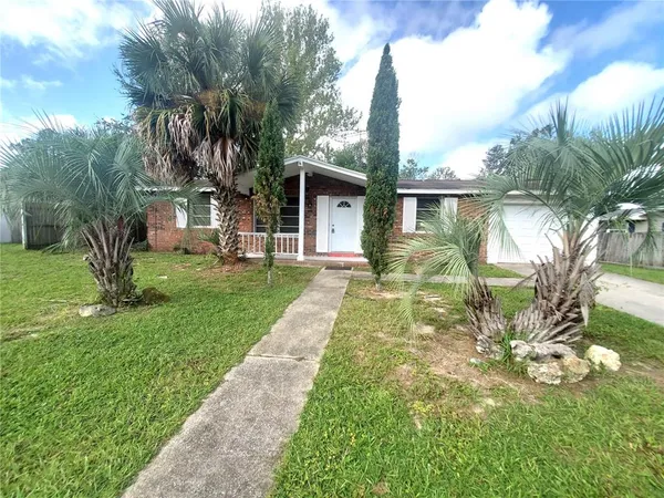 a front view of house with yard and green space