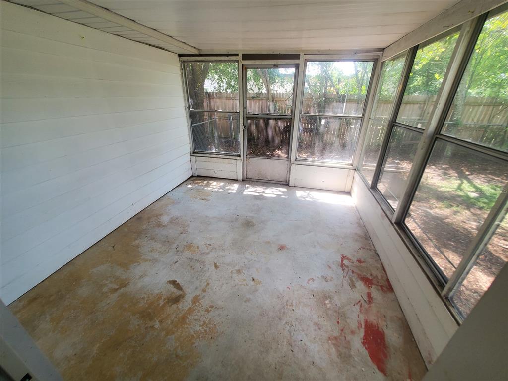 14576 Southwest 34th Terrace Road Ocala, FL 34473 - Photo 11 of 11 a view of an empty room with a sliding door