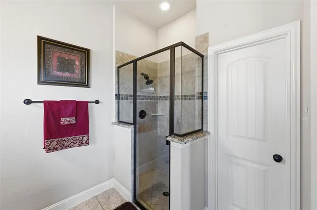 a bathroom with a shower and a sink