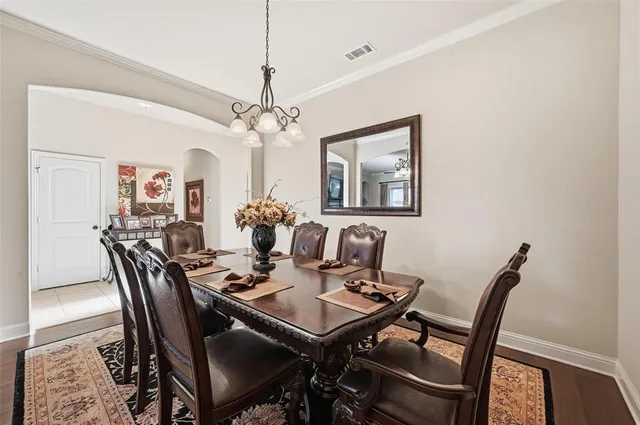 a view of a dining room with furniture and chandelier