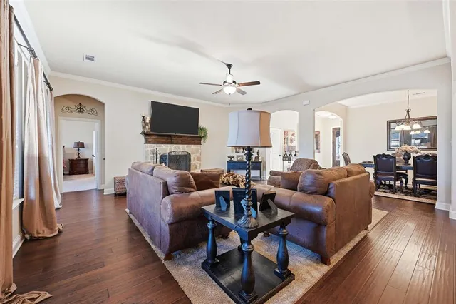 a living room with furniture flat screen tv and wooden floor