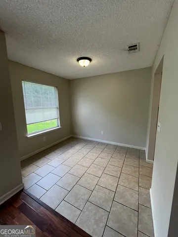 a view of an empty room and a window