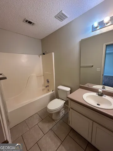 a bathroom with a sink a toilet a mirror and vanity