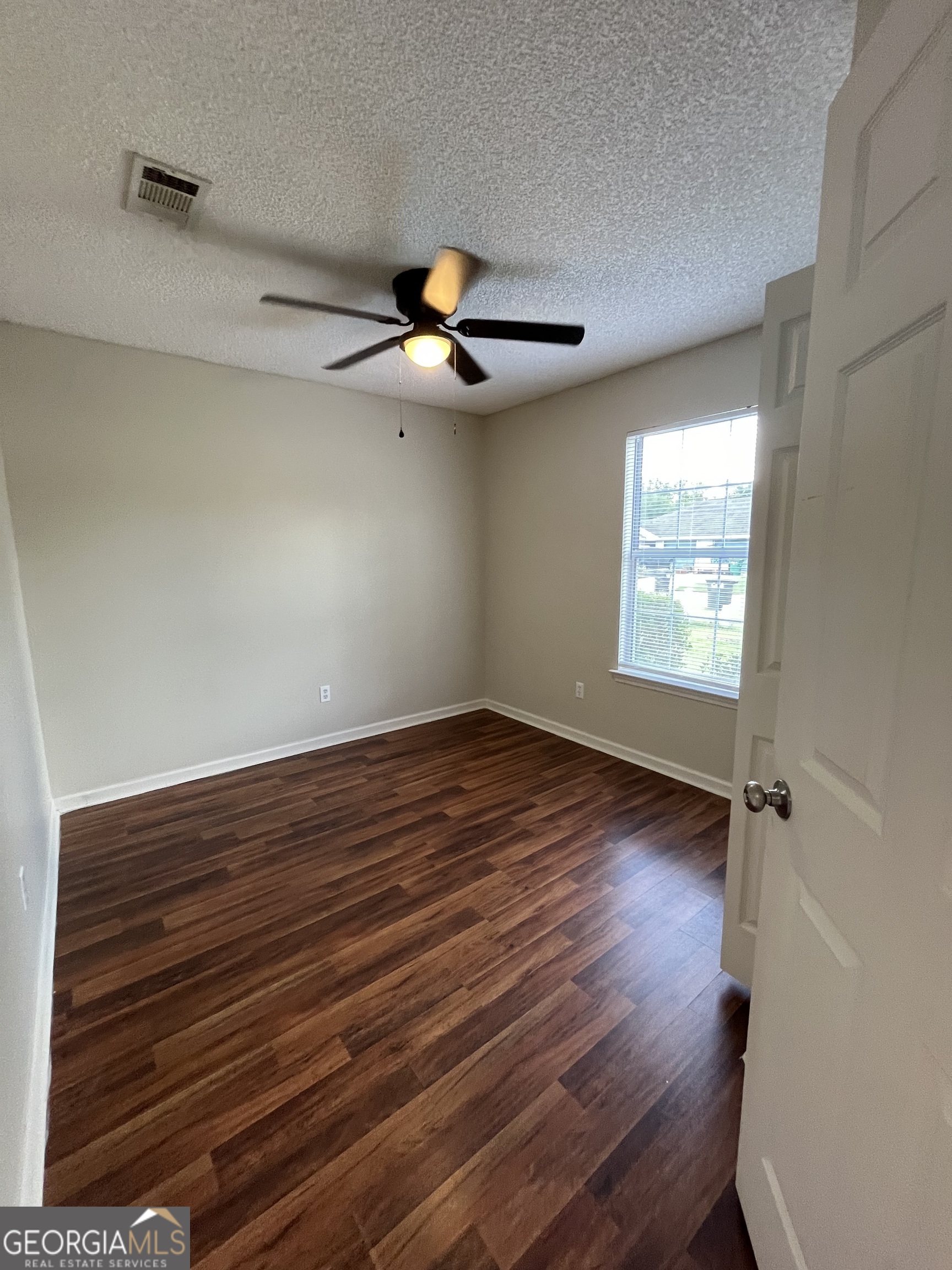 15 Talbot Court St. Marys, GA 31558 - Photo 3 of 20 a view of an empty room with wooden floor and a window