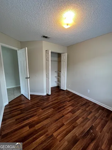 a view of an empty room and wooden floor