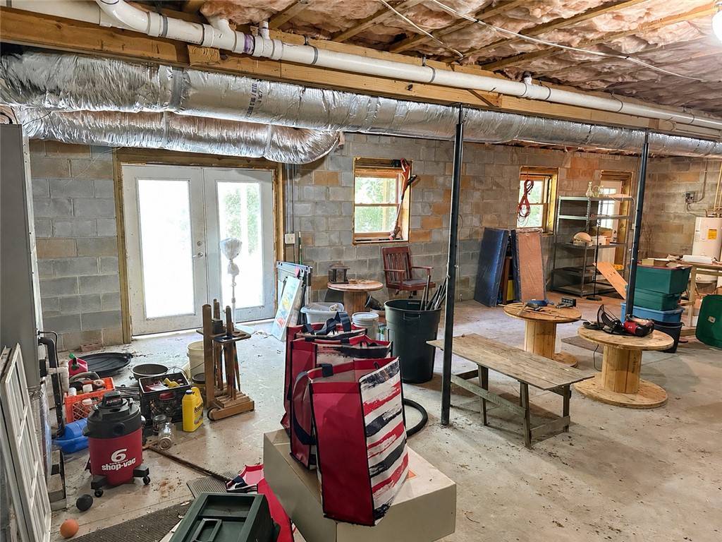 138 Cloverdale Road Seneca, SC 29678 - Photo 25 of 27 A spacious unfinished basement with a walk-out entrance, awaiting transformation.