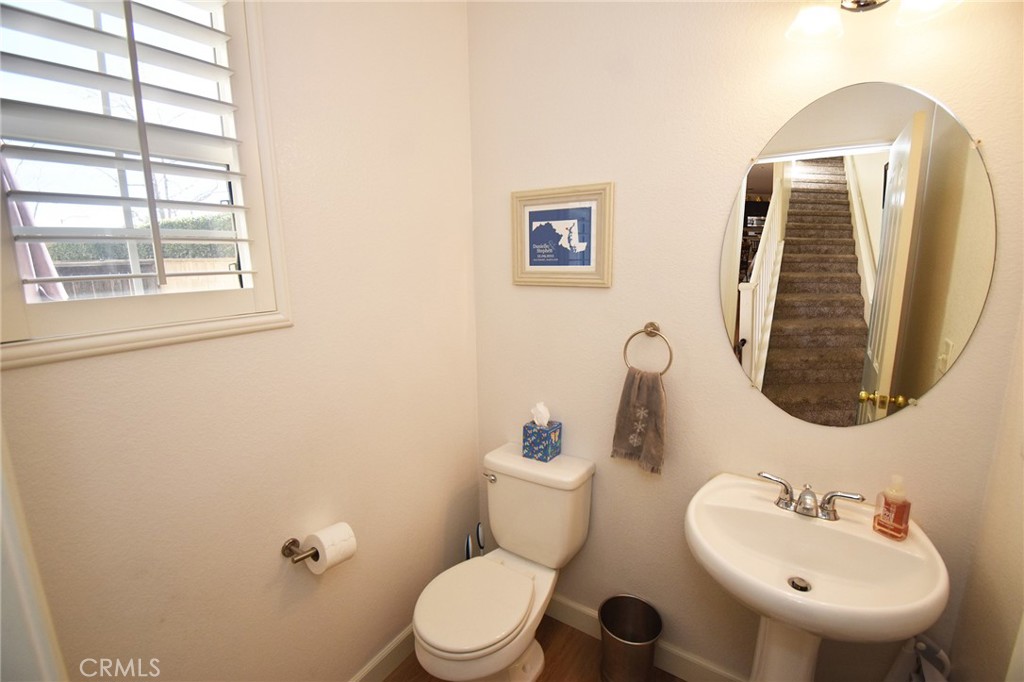 7353 Ellena West, Unit 70 Rancho Cucamonga, CA 91730 - Photo 11 of 40 a bathroom with a toilet sink and mirror