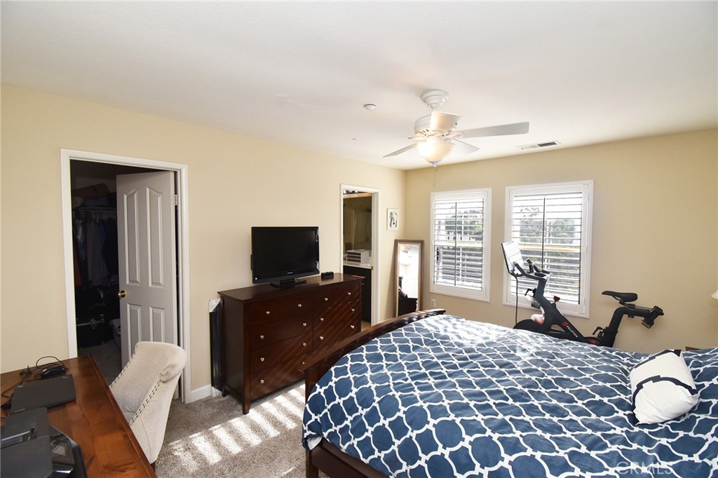 7353 Ellena West, Unit 70 Rancho Cucamonga, CA 91730 - Photo 14 of 40 a bedroom with a bed and wooden floor