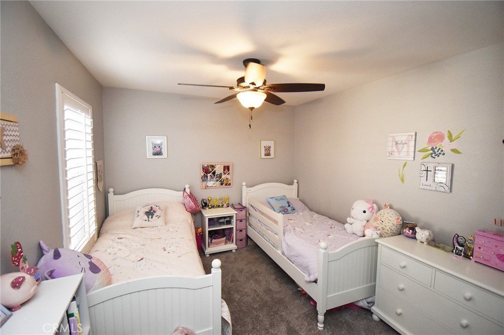 7353 Ellena West, Unit 70 Rancho Cucamonga, CA 91730 - Photo 18 of 40 a bedroom with a bed and a chandelier