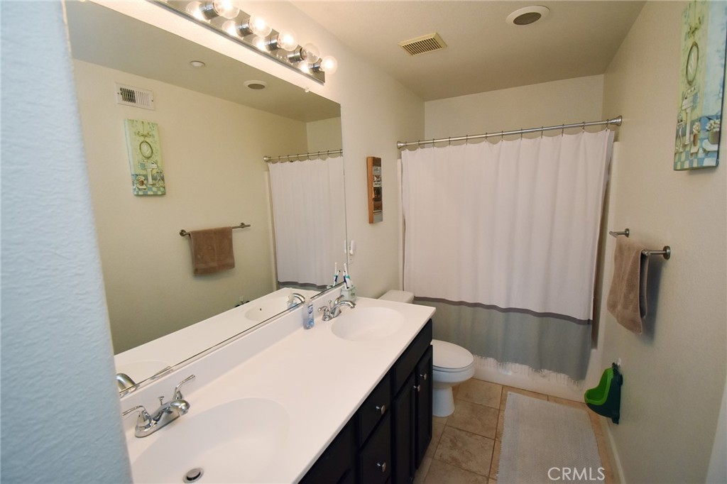 7353 Ellena West, Unit 70 Rancho Cucamonga, CA 91730 - Photo 20 of 40 a bathroom with a sink a toilet and shower
