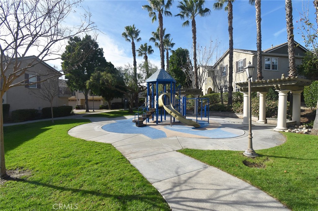 7353 Ellena West, Unit 70 Rancho Cucamonga, CA 91730 - Photo 23 of 40 a view of a park with swings and slides