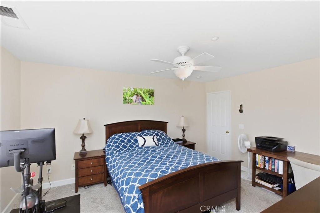 7353 Ellena West, Unit 70 Rancho Cucamonga, CA 91730 - Photo 27 of 40 a bedroom with a bed and chandelier