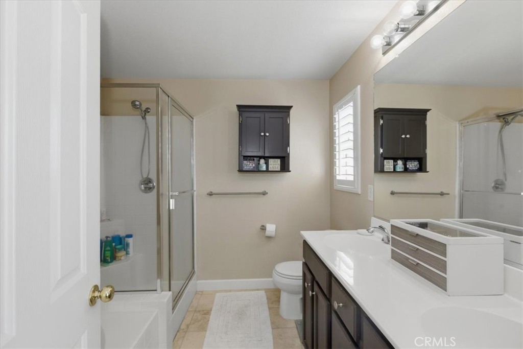 7353 Ellena West, Unit 70 Rancho Cucamonga, CA 91730 - Photo 29 of 40 a bathroom with a sink a toilet and shower