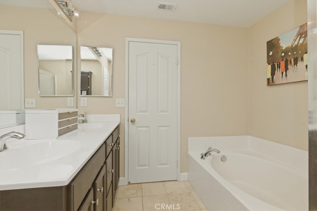7353 Ellena West, Unit 70 Rancho Cucamonga, CA 91730 - Photo 31 of 40 a bathroom with a tub a sink and mirror