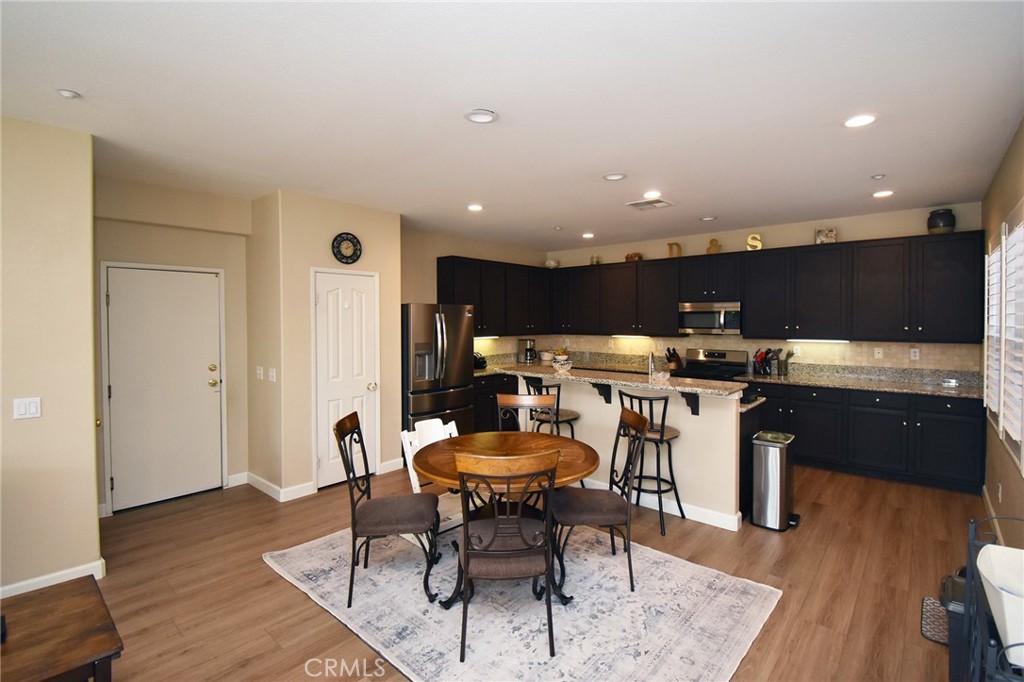 7353 Ellena West, Unit 70 Rancho Cucamonga, CA 91730 - Photo 7 of 40 a kitchen with a table and chairs in it