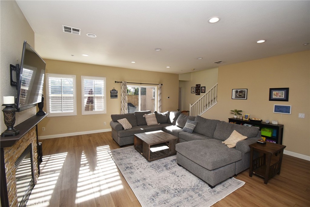 7353 Ellena West, Unit 70 Rancho Cucamonga, CA 91730 - Photo 8 of 40 a living room with furniture and wooden floor