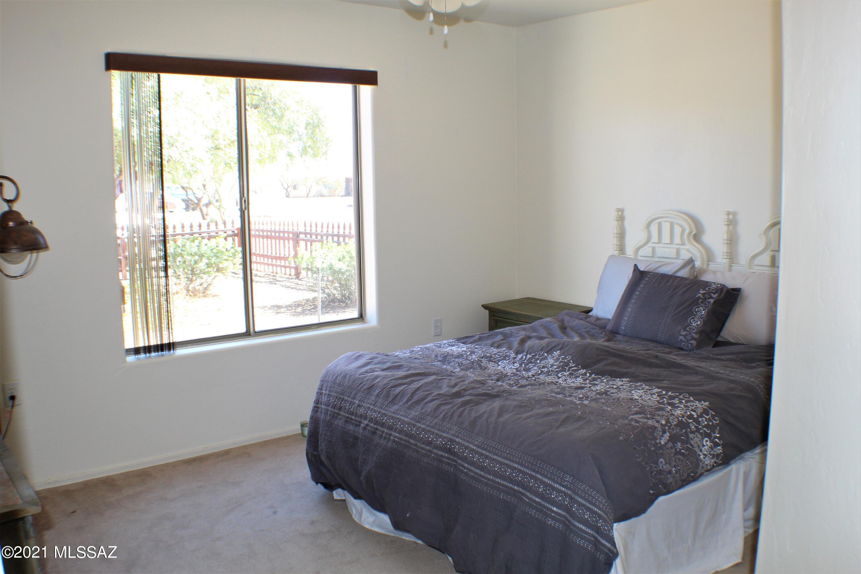 1704 Leary Court Rio Rico, AZ 85648 - Photo 32 of 37 a bed sitting in a bedroom next to a window