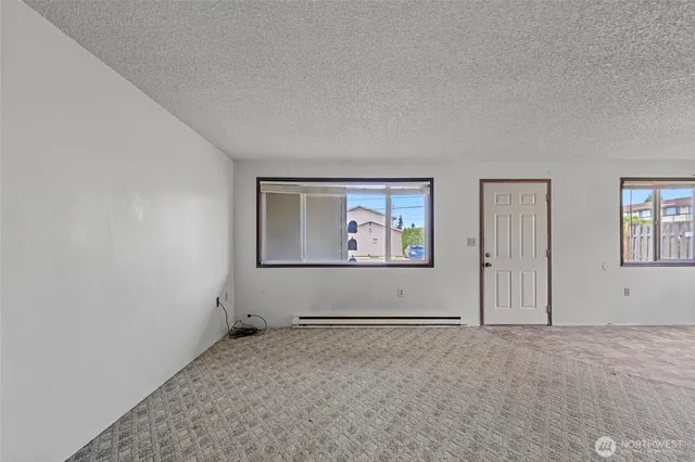 an empty room with windows and closet