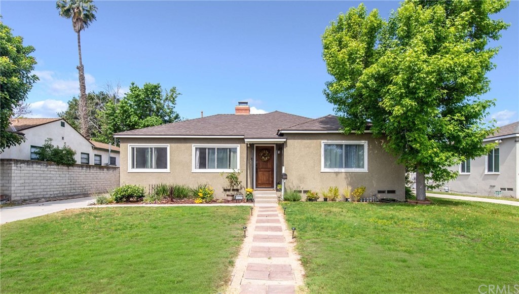 4335 Rutgers Avenue Long Beach, CA 90808 - Photo 1 of 1 a front view of a house with a garden and yard