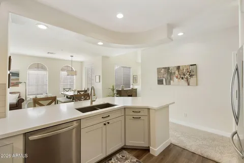 a view of a kitchen with center island and stainless steel appliances